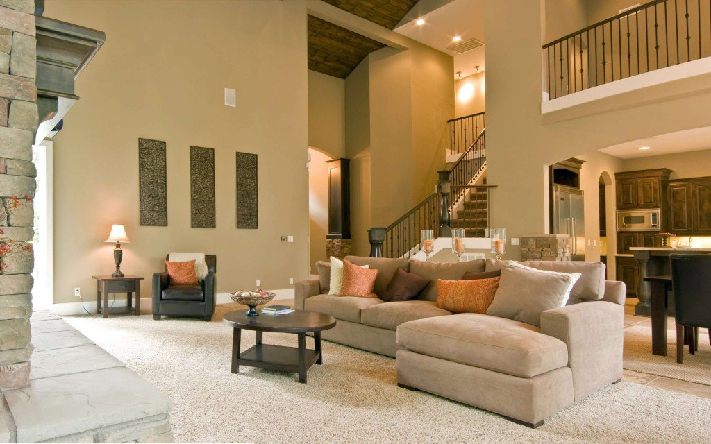 A clean and inviting living room with a comfortable sofa and ottoman, maintained by Nooks and Crannies Cleaning Services in Norfolk, VA.