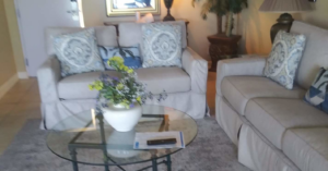 A sparkling clean living room with comfortable sofas and a coffee table, expertly cleaned by Tangie's Cleaning Service in Syracuse, NY.