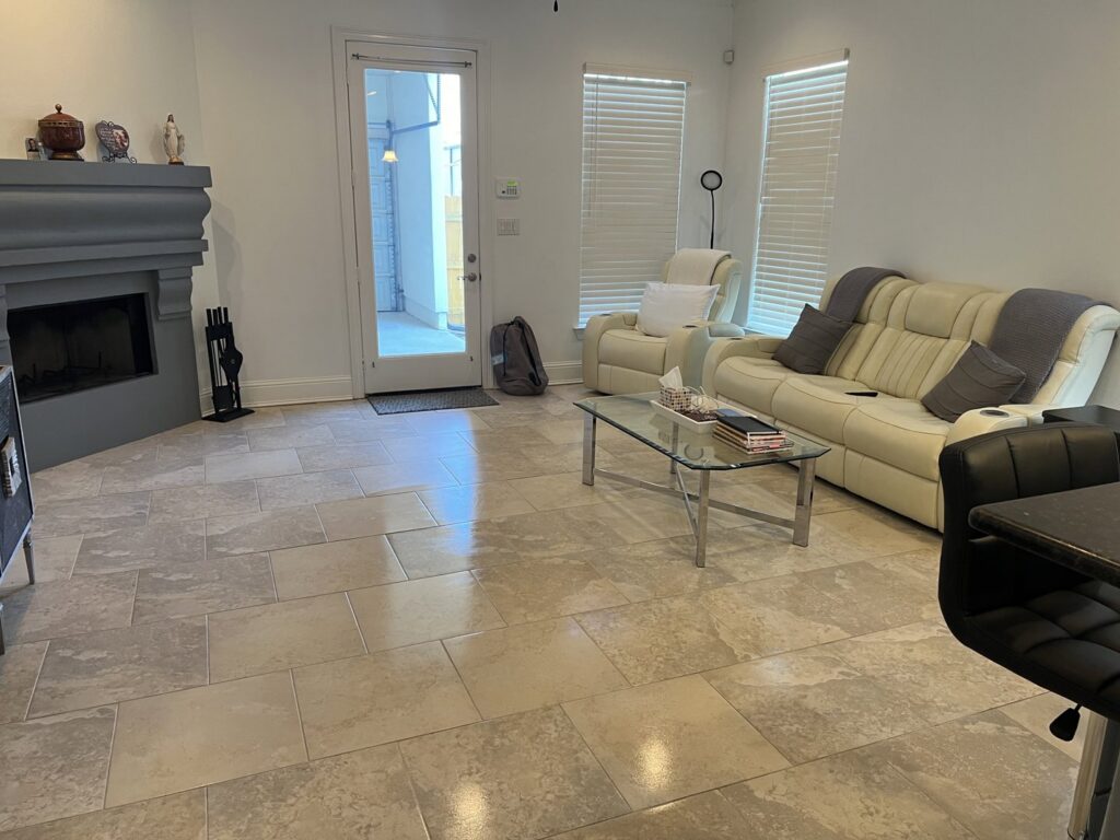 A bright and clean living room with a polished tiled floor, reflecting the quality house cleaning service of JBO Cleaning Services in Belle Chasse, LA.