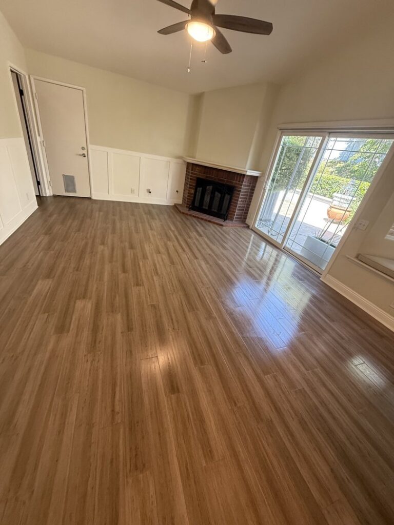 A beautifully cleaned living room with polished wooden floors and a fireplace by Cleaning Service Masters LLC in Escondido, CA