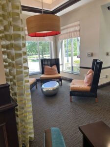 A clean lounge area with chairs and carpet, representing house cleaning services by Time To Shine Cleaning Services in Round Rock, TX.