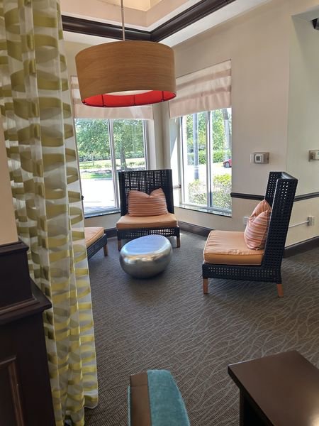 A clean lounge area with chairs and carpet, representing house cleaning services by Time To Shine Cleaning Services in Round Rock, TX.