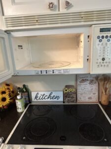 A clean microwave interior and stovetop, demonstrating thorough kitchen appliance cleaning by Wilkie Wonders Cleaning in Akron, OH.