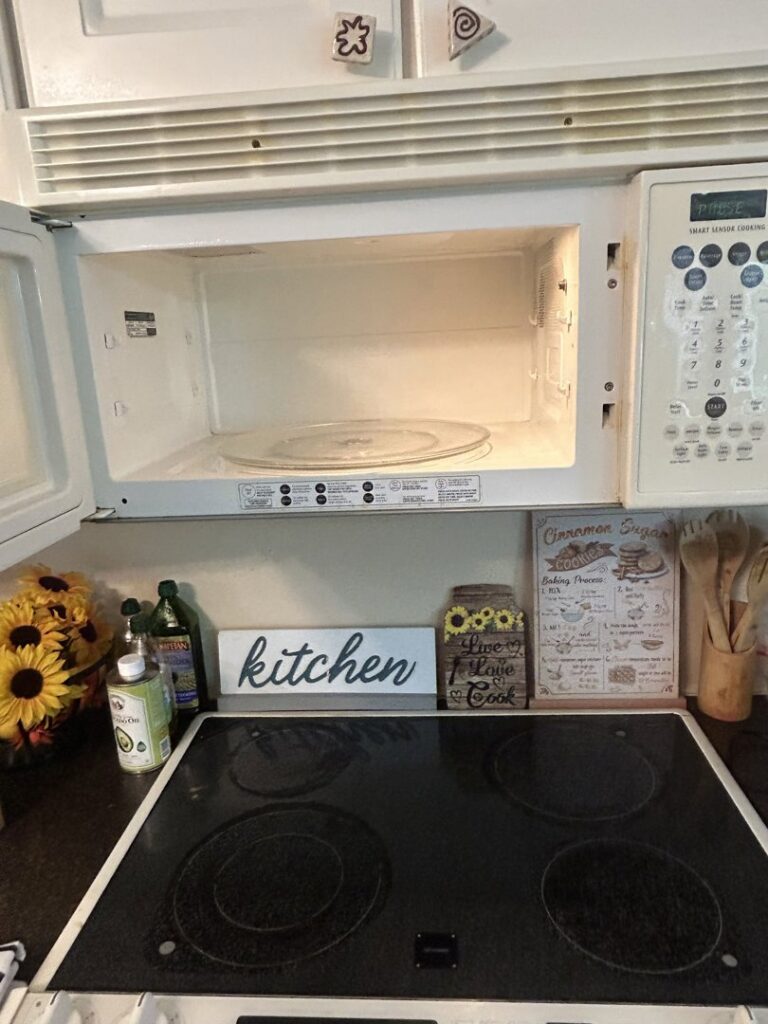 A clean microwave interior and stovetop, demonstrating thorough kitchen appliance cleaning by Wilkie Wonders Cleaning in Akron, OH.
