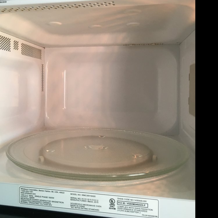 The pristine interior of a microwave oven after a thorough cleaning by Magic Maids in Bremen, AL.