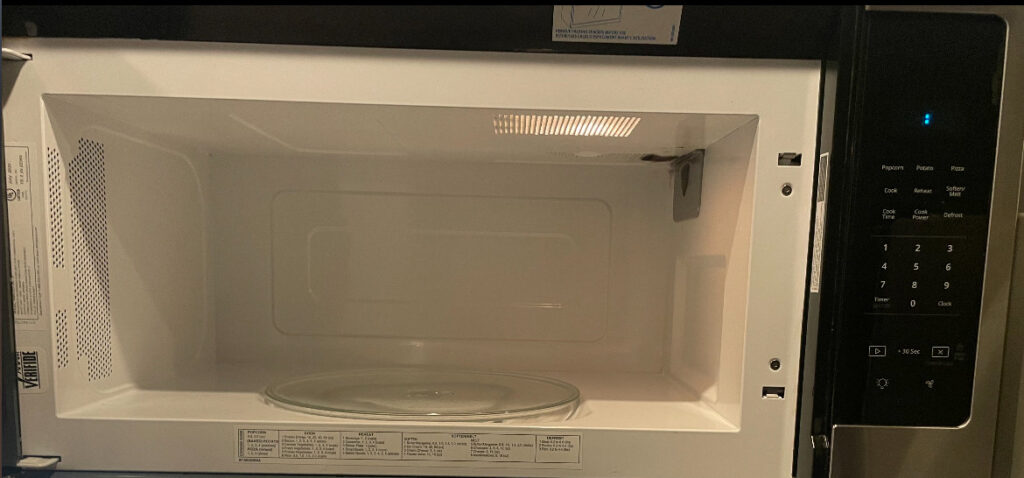 The clean interior of a microwave oven, demonstrating the detailed appliance cleaning services of Merriweather Cleaning and Laundry in Vancouver, WA.