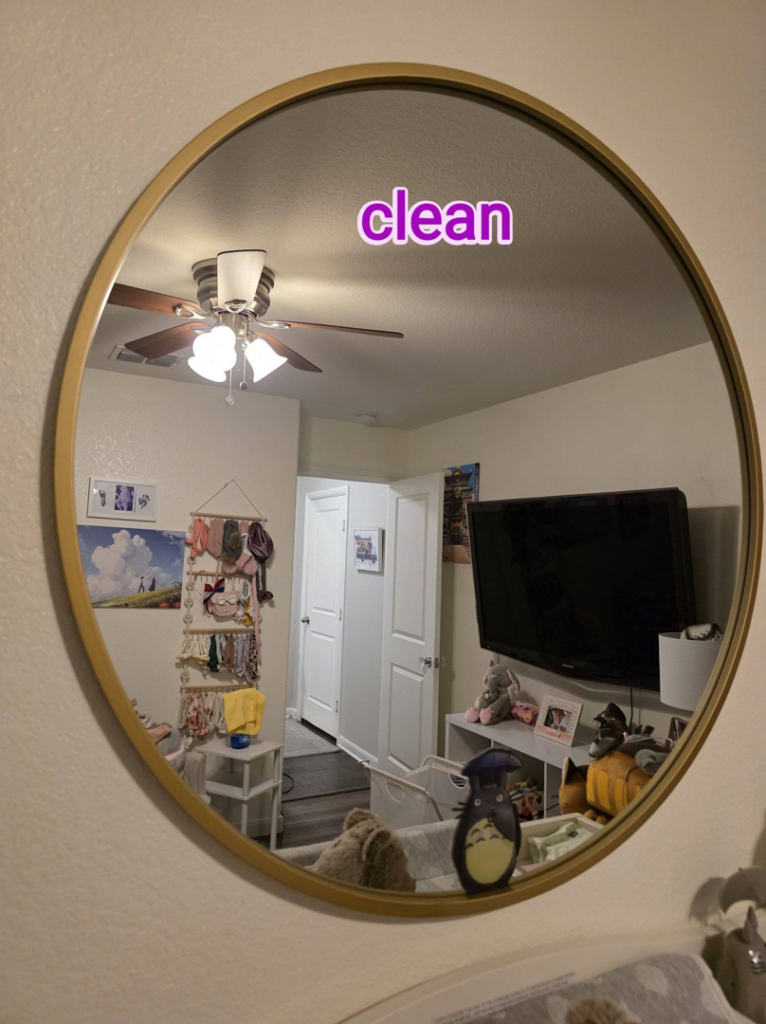 A sparkling clean mirror in a bedroom, showcasing the results of Rita's cleaning service in Fort Worth, TX.