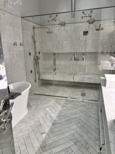 A pristine modern bathroom with a large glass shower and freestanding tub, expertly cleaned by Bee Clean Solutions in Lexington, KY.
