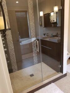 A clean modern bathroom featuring a glass shower and double vanity by Cooper-N-Folks in Philadelphia, PA