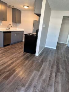 A clean, modern kitchen with dark cabinets and appliances after professional house cleaning by Nannie Needs LLC in Kent, WA.