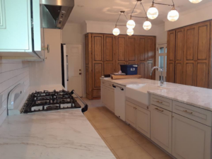 A clean and modern kitchen with an island and gas range, showcasing house cleaning services by Inside & Out Residential Cleaning & Lawn Care in Yulee, FL.