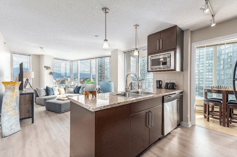 A sparkling clean modern kitchen and living room, showcasing the results of Trust-Clean's services in Green Bay, WI.
