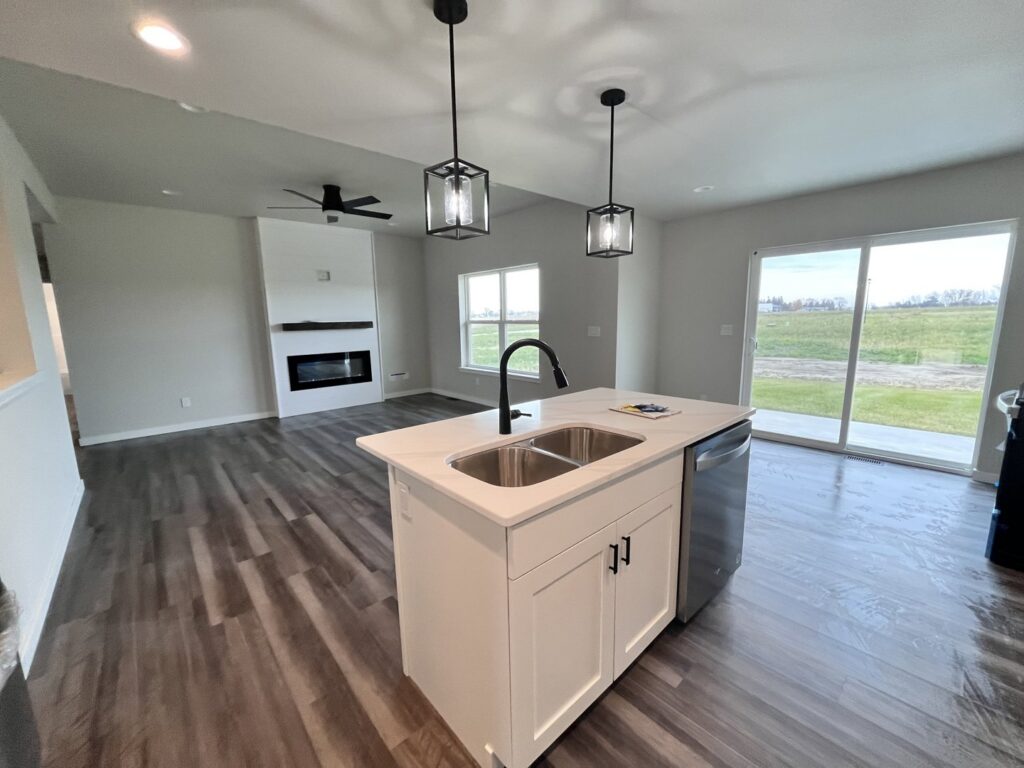 A clean, modern kitchen and living room with a freshly mopped wet floor, showcasing a completed cleaning job by Cedar Cleaners LLC in Cedar Rapids, IA.