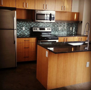 A clean modern kitchen with wooden cabinets and stainless steel appliances, tidied by Per Your Request Richmond in Glen Allen, VA.