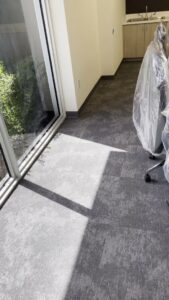 A clean carpeted floor in an office setting with chairs covered in plastic, indicating professional cleaning by YQP Cleaning Services in Miami, FL.