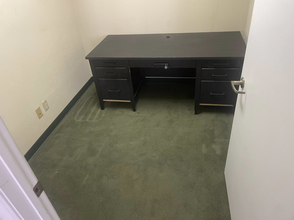 A sparkling clean office desk in a small room after professional cleaning by Sister cleaning consultant in Fresno, CA.
