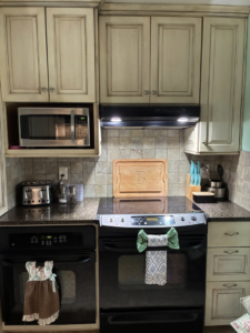 A sparkling clean and organized kitchen counter with appliances and cabinets, showcasing the results of Royalty Cleaning LLC in Fresno, CA.