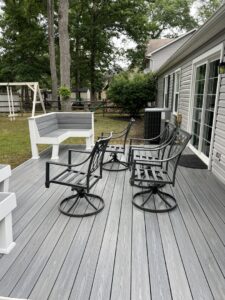 A freshly cleaned outdoor deck with furniture, showcasing the results of Miles Dynamic Cleaning in Baltimore, MD