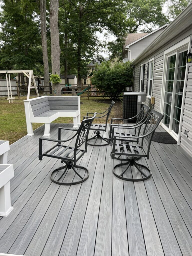 A freshly cleaned outdoor deck with furniture, showcasing the results of Miles Dynamic Cleaning in Baltimore, MD