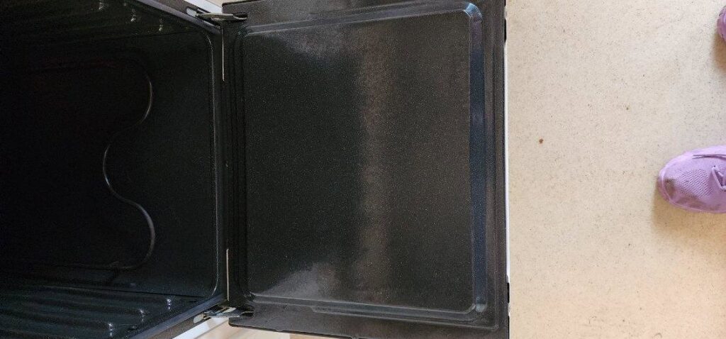 A spotless oven door interior, showcasing the thorough deep cleaning services offered by Sparkle & Shine of Iowa in Urbandale, IA.