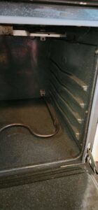 A sparkling clean oven interior with racks removed, showcasing the deep cleaning services provided by Sparkle & Shine of Iowa in Urbandale, IA.