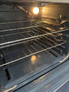 A clean oven interior with shiny racks, demonstrating deep cleaning service by Cleaning with Lisseth in Madison, WI.