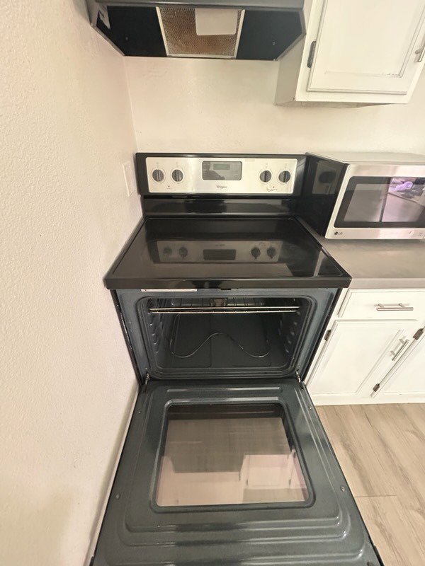 A meticulously cleaned oven interior of an electric stove, demonstrating the deep cleaning services offered by Carole's House Cleaning in Tempe, AZ.