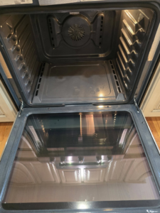 A sparkling clean oven interior after professional cleaning by Wonderful Laura Cleaning in Aurora, IL.