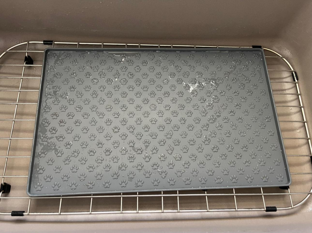 A clean pet feeding mat resting in a kitchen sink, sparkling after a thorough cleaning by Spotless by Sam LLC in Green Bay, WI.