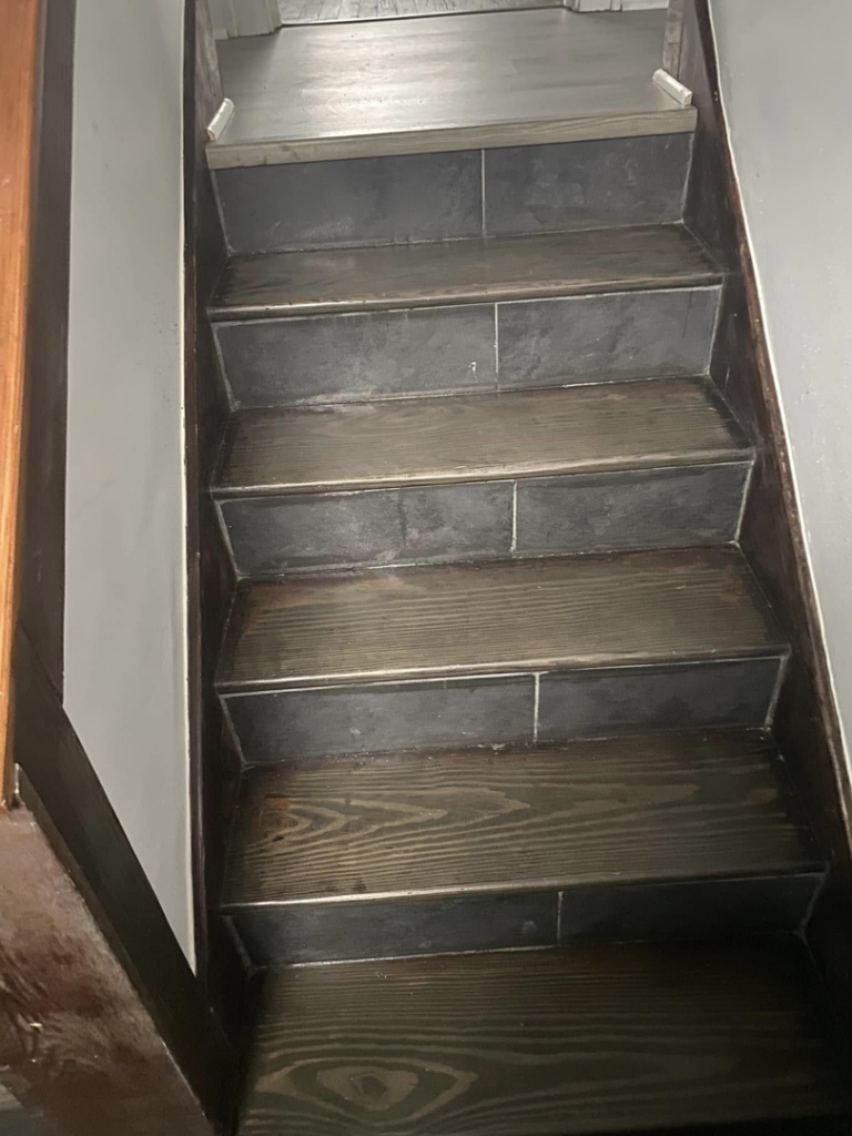A beautifully clean and polished staircase, showcasing the detailed work of Kings and Queens of the Most High Cleaning Services in Akron, OH.
