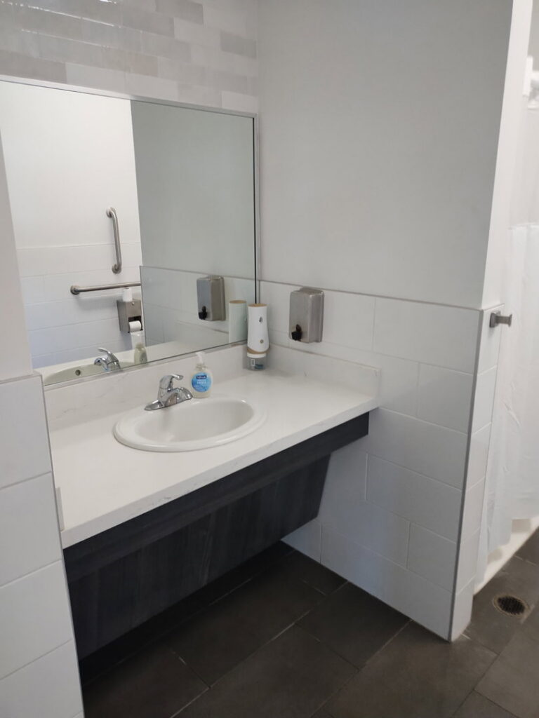 A clean public restroom vanity with a sink and mirror, maintained by Green Leaf Janitorial in Gilbert, AZ.