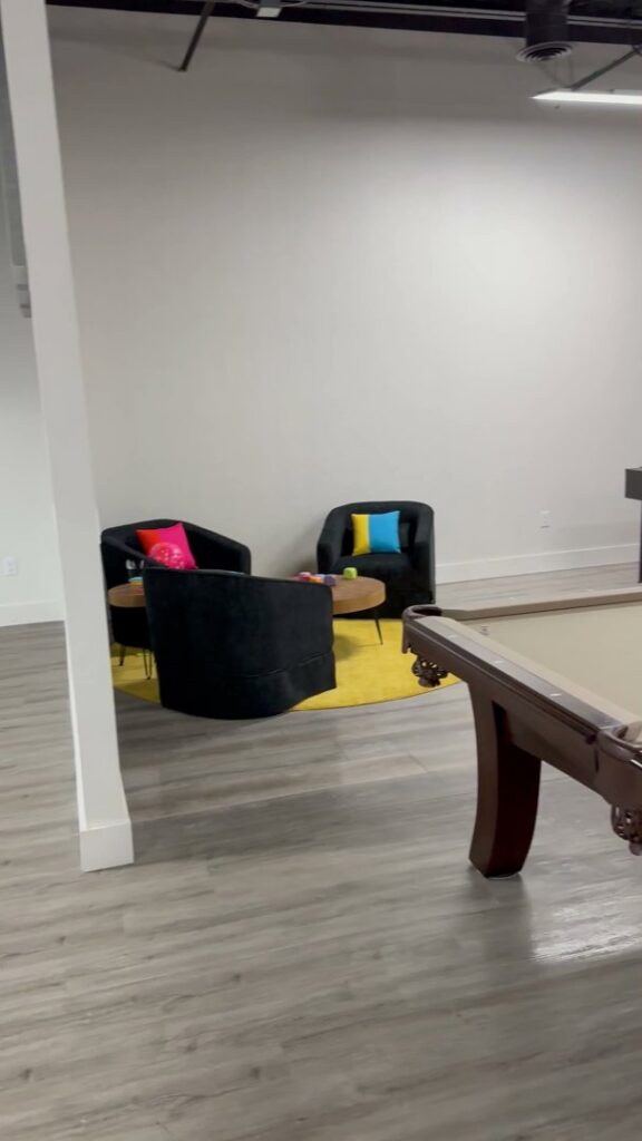 A clean and inviting recreational room featuring a pool table and seating area, maintained by Inspire Clean OKC in Oklahoma City, OK.