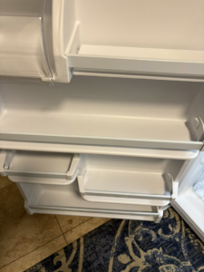 Spotless and organized shelves inside a refrigerator door, professionally cleaned by Sprinkled Clean in Bangor, ME.