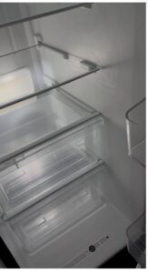 Clean refrigerator drawers and interior, showcasing the excellent cleaning results by Bee-Dazzled Cleaning Service in Long Beach, CA.