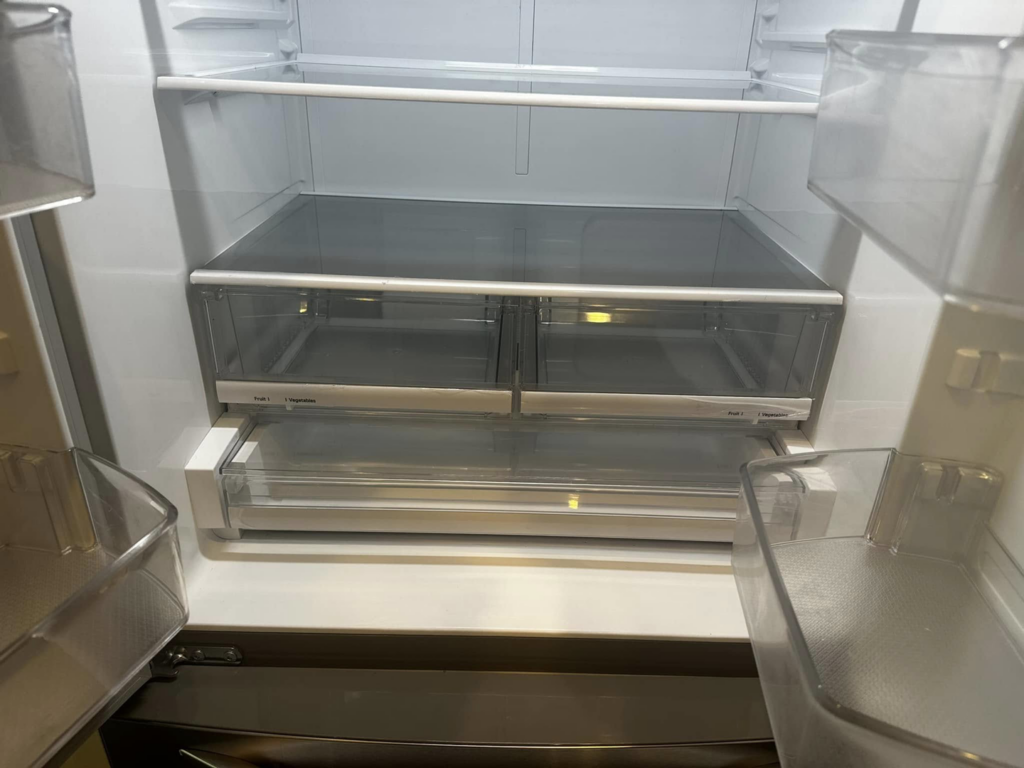 Clean and organized refrigerator drawers and shelves, showcasing the detailed cleaning by Sara's House Cleaning in Olathe, KS.