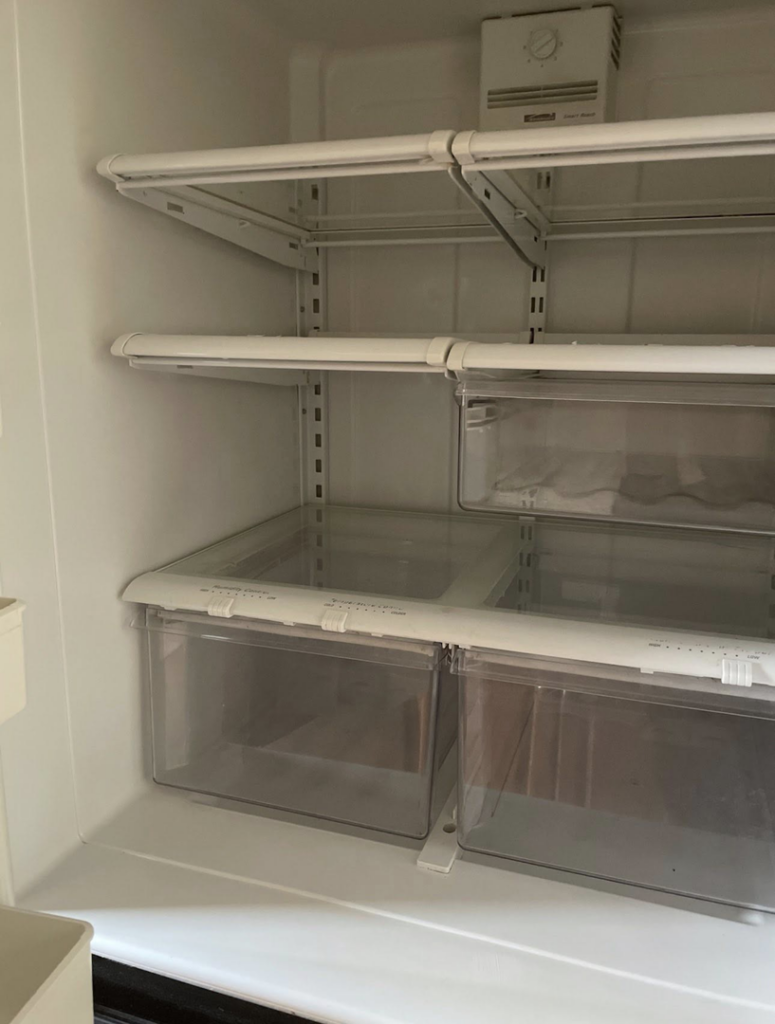 A sparkling clean refrigerator interior with shelves and drawers, showcasing the professional results from Crystal Clear Cleaning Services in New Haven, CT