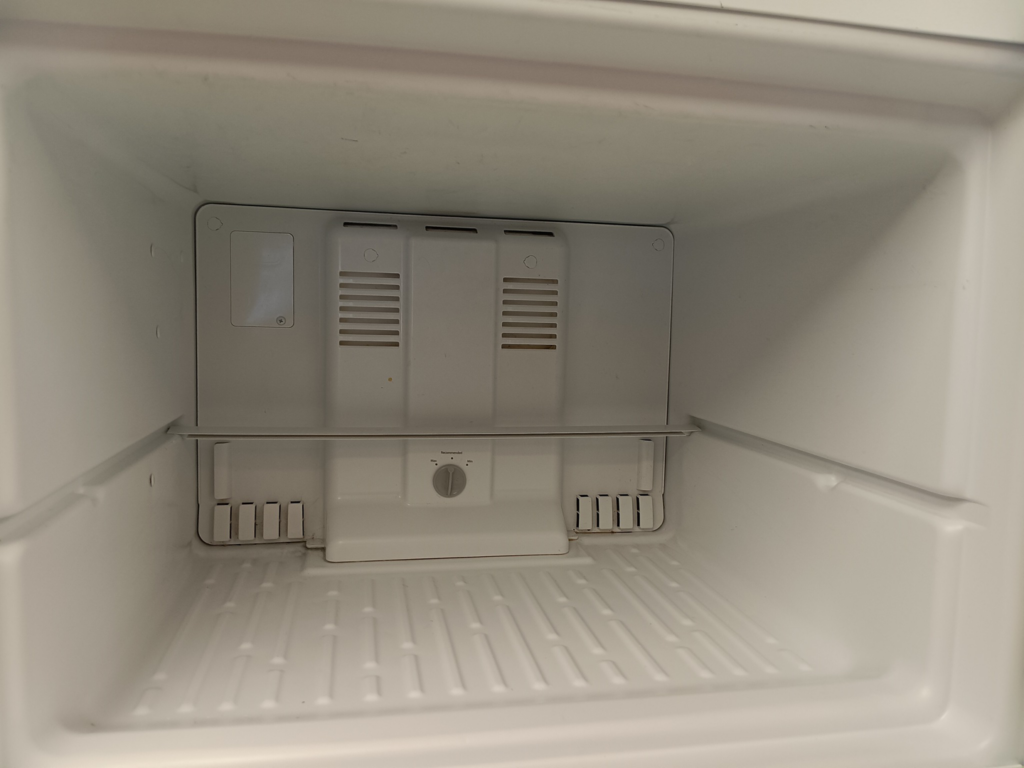 A sparkling clean and empty refrigerator interior after professional cleaning by KB Cleaning in Bozeman, MT.