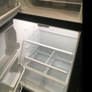 An immaculately clean refrigerator interior, showcasing deep cleaning services by Magic Maids in Bremen, AL.