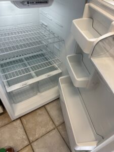 The clean interior of a refrigerator with shelves and drawers, demonstrating thorough appliance cleaning by CLEAN That SHEET LLC in Jacksonville, FL.