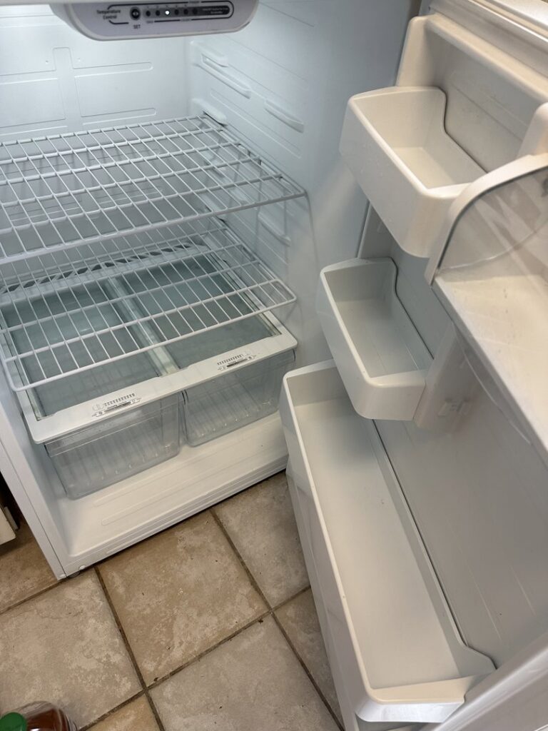 The clean interior of a refrigerator with shelves and drawers, demonstrating thorough appliance cleaning by CLEAN That SHEET LLC in Jacksonville, FL.