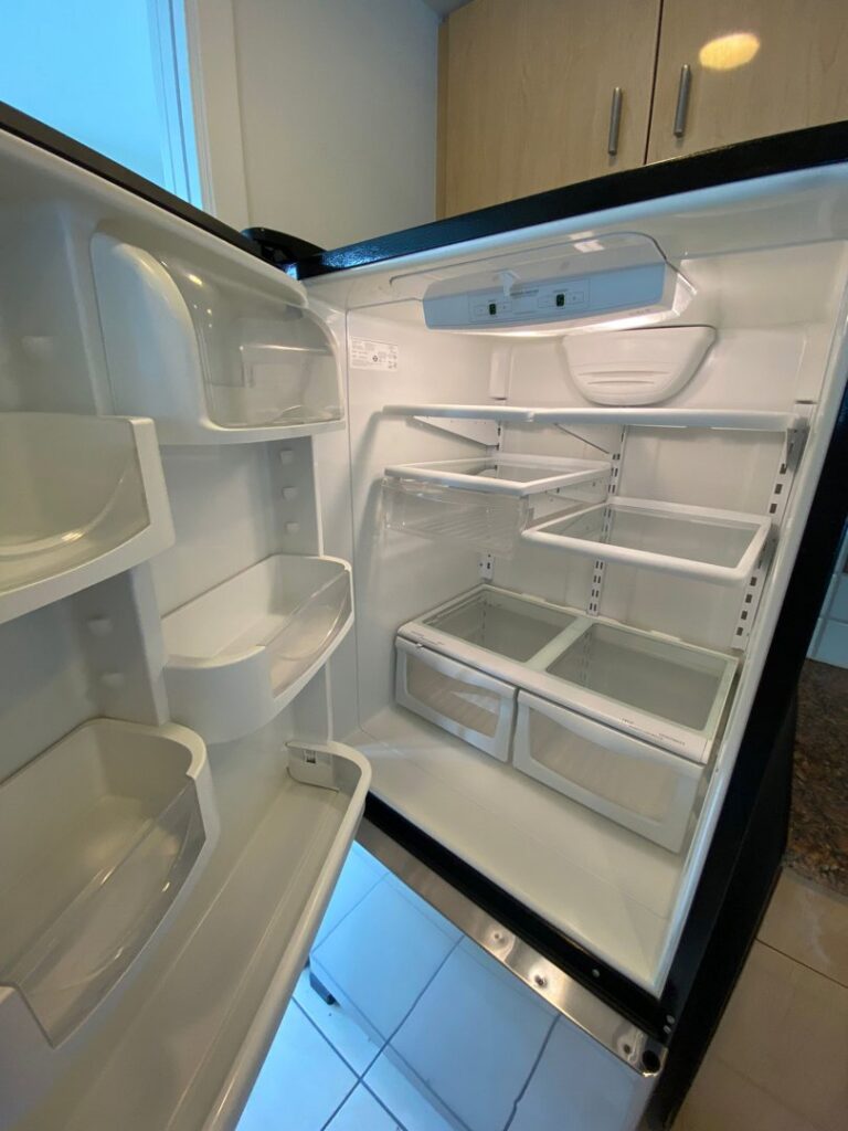 A meticulously cleaned refrigerator interior, showcasing Trust-Clean's comprehensive cleaning services in Green Bay, WI.