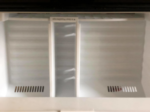 A meticulously cleaned refrigerator door with "In-Door Pizza Storage" compartment, cleaned by Refresh Cleaning Company in Hazelwood, MO.