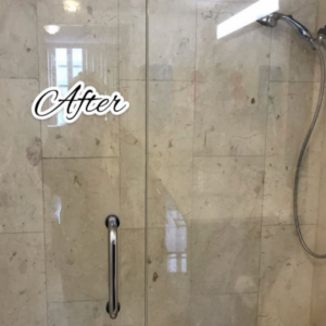 A sparkling clean shower glass door and tiled wall after cleaning by Lourdes Home Cleaning in East Hampton, NY.