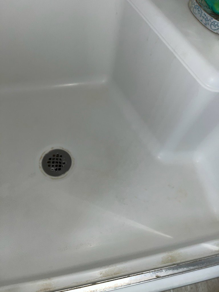 A sparkling clean shower floor after professional cleaning by No Stress Cleaning Services in Virginia Beach, VA