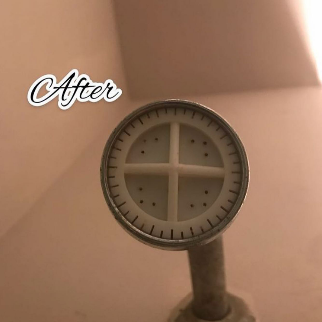 A sparkling clean shower head after professional bathroom cleaning by Lourdes Home Cleaning in East Hampton, NY.