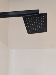 A perfectly clean shower head, free of hard water stains, showcasing the effective cleaning services of White Rose Cleaning in Idaho Falls, ID.
