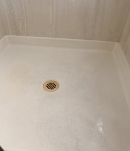 A sparkling clean shower pan after professional cleaning by Lindi's Clean Living, LLC in Tucson, AZ.