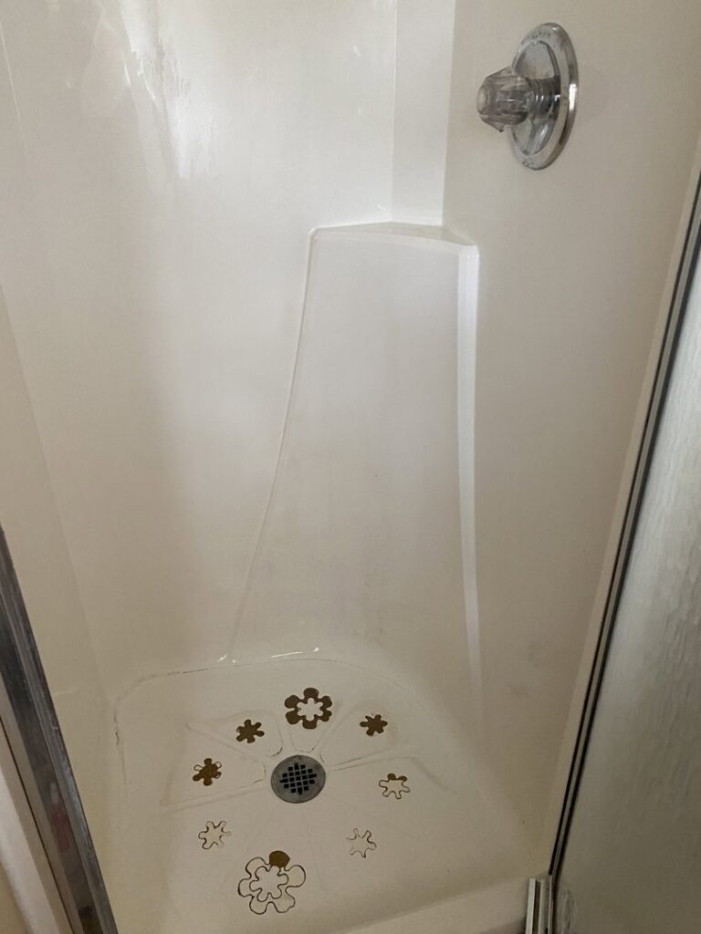 A spotless white shower stall after professional cleaning by Jenny Can Cleaning Company in Canton, OH