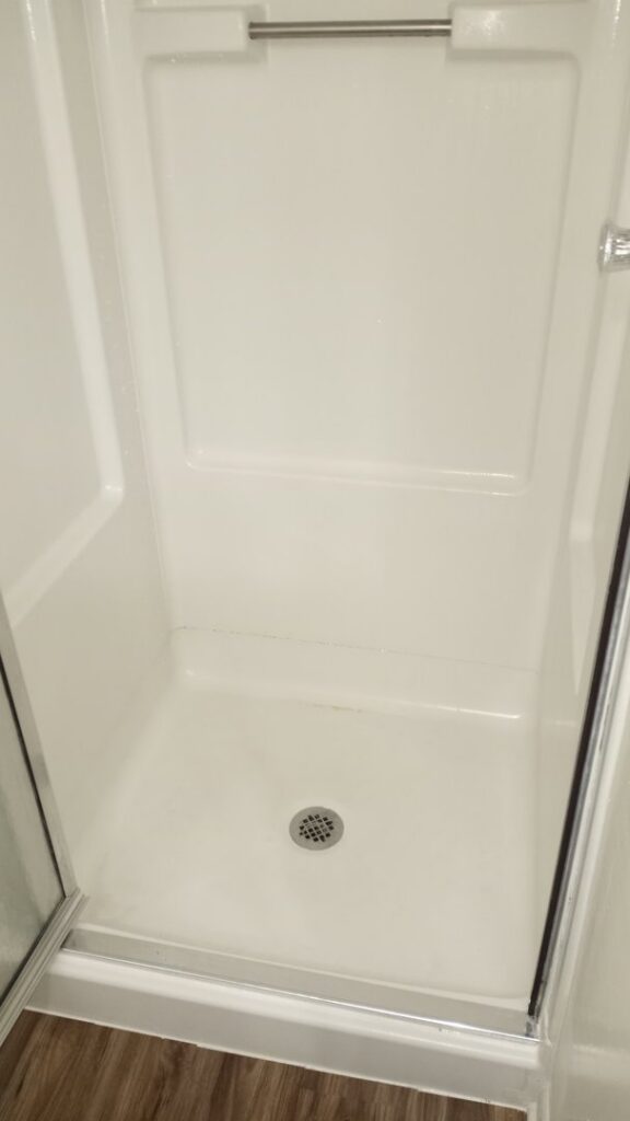 A clean and sanitized shower stall after professional cleaning by By Grace Cleaning Solutions, LLC in Cincinnati, OH.