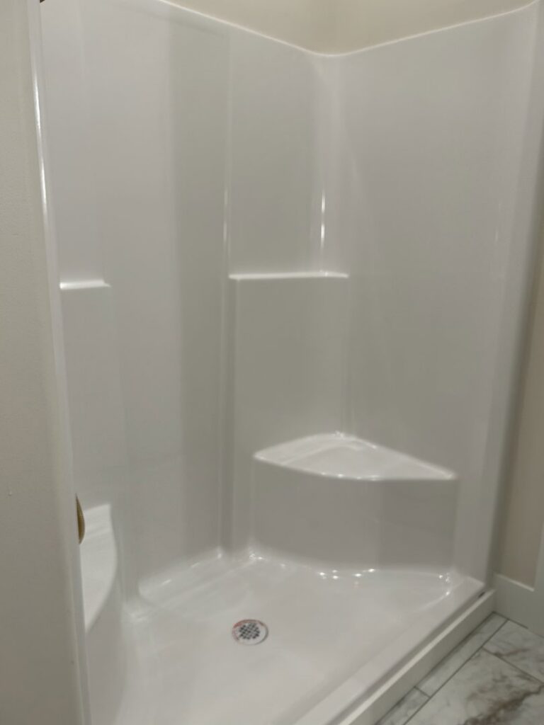 A pristine white shower stall, professionally cleaned by Martinez Cleaning Services in Kent, WA